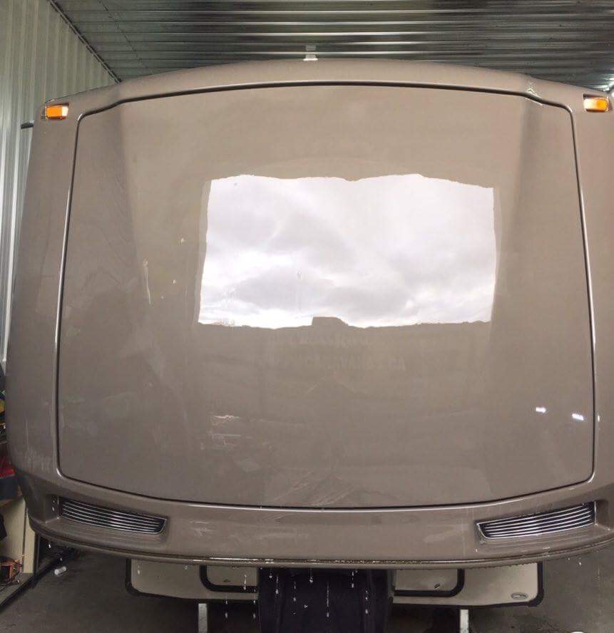 Manufacturer after example: RV front panel reflecting the overhead lighting